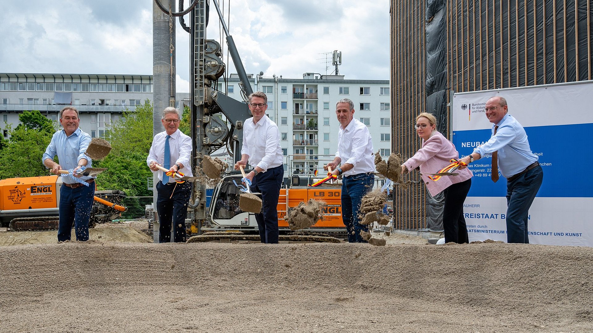 The speakers break ground for the building.
