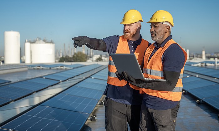 Two engineers inspect a photovoltaic system.