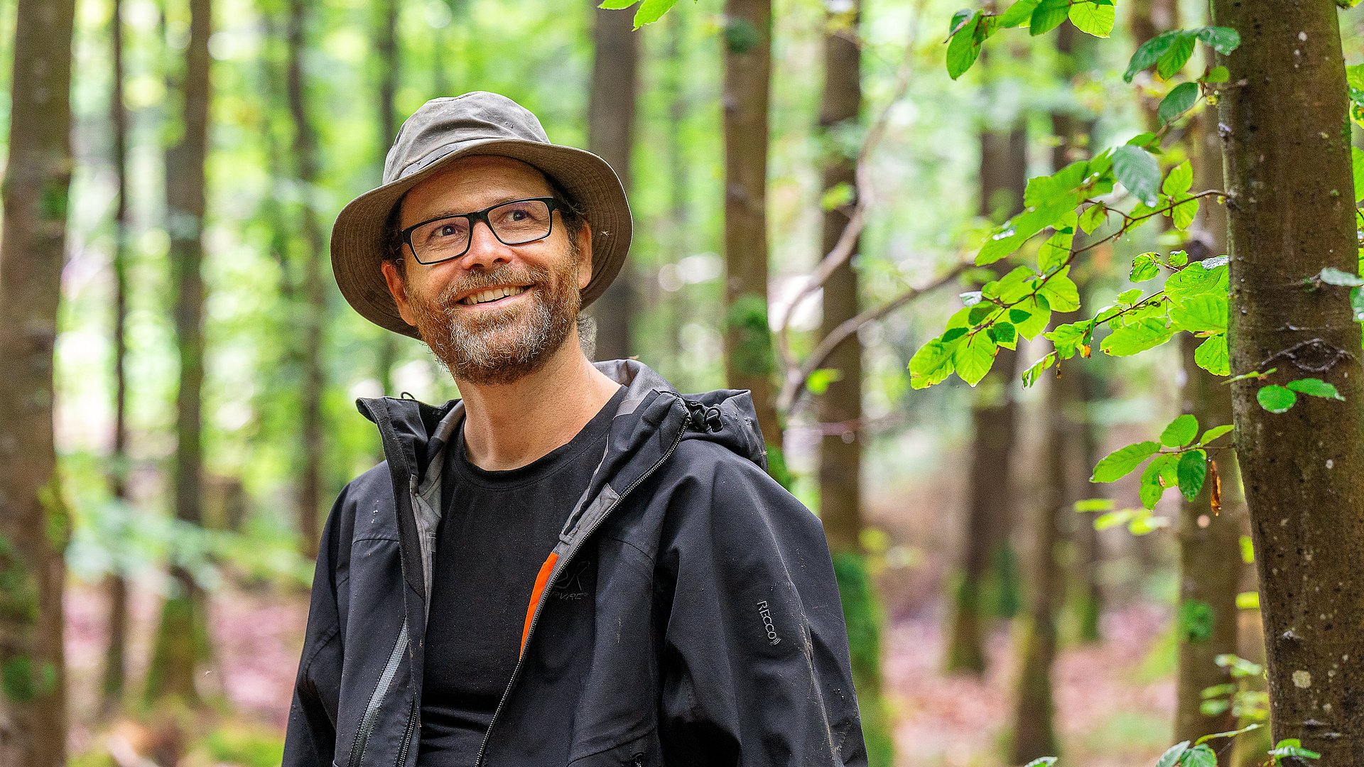 Prof. Rupert Seidl doing research in a forest. 