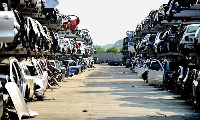 Vehicles stacked on top of each other in a scrapyard