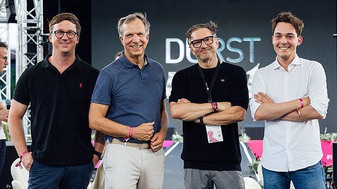 Patrick Pfaff, Managing Director of TUM Venture Labs Robotics / AI, Philipp Gerbert, CEO of TUM Venture Labs, Christoph Gamper, CEO of the Durst Group, and Philip Moedinger, Corporate Development Analyst at Durst, announce the partnership.