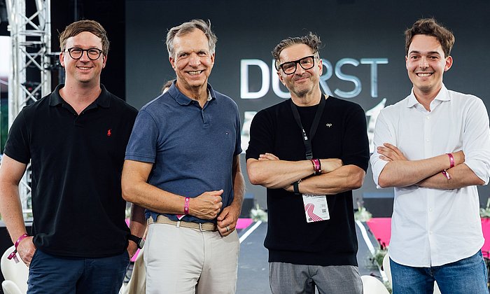 Patrick Pfaff, Managing Director of TUM Venture Labs Robotics / AI, Philipp Gerbert, CEO of TUM Venture Labs, Christoph Gamper, CEO of the Durst Group, and Philip Moedinger, Corporate Development Analyst at Durst, announce the partnership.