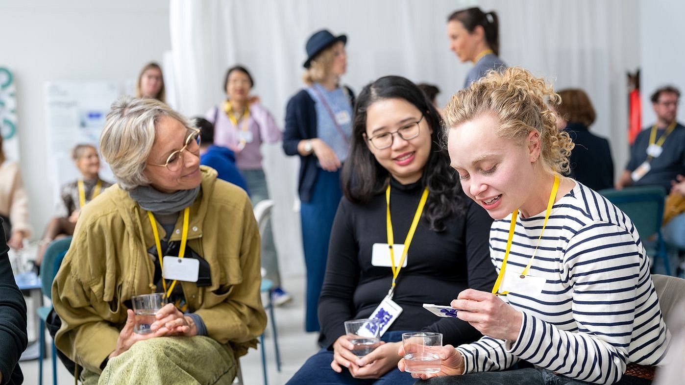 Participants in the “Creative Collisions” event discuss with each other.