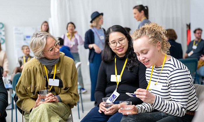 Participants in the “Creative Collisions” event discuss with each other.