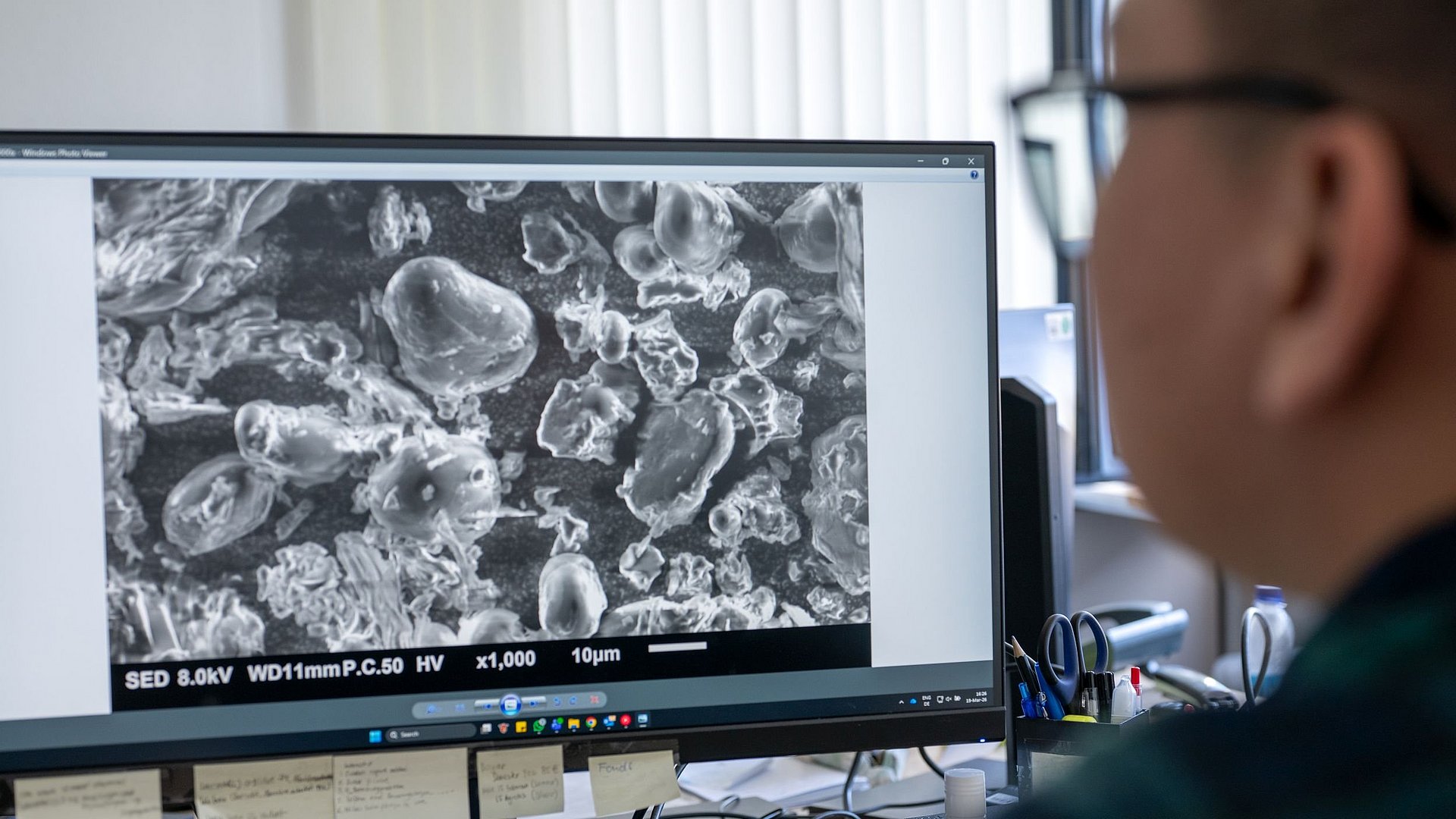 Victor Christian Kaharso examines research results on his PC.