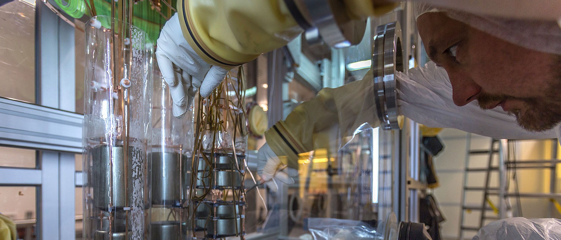 A scientist works on the germanium detector array in the clean room of Gran Sasso underground laboratory.