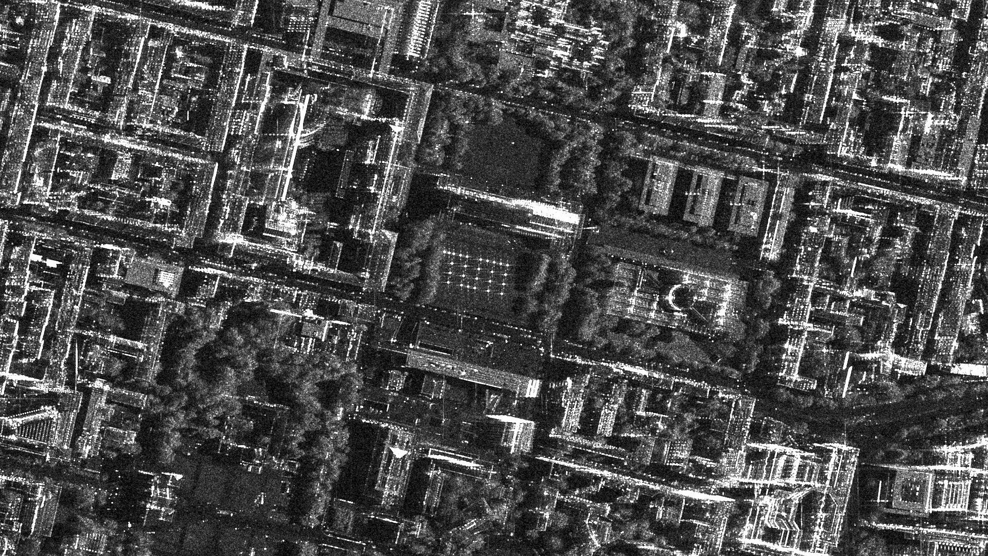 Black-and-white satellite image of the TUM logo on the southern lawn of the Pinakothek. 