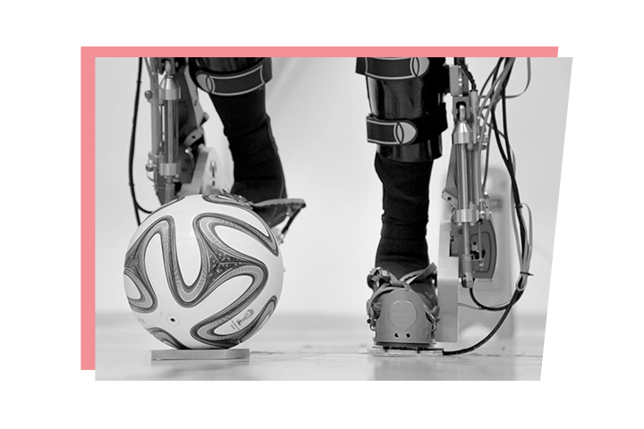 Legs within a powered exoskeleton kicking a ball