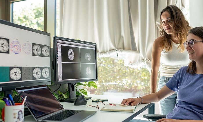 Vasiliki Sideri-Lampretsa with a colleague in front of PC screens