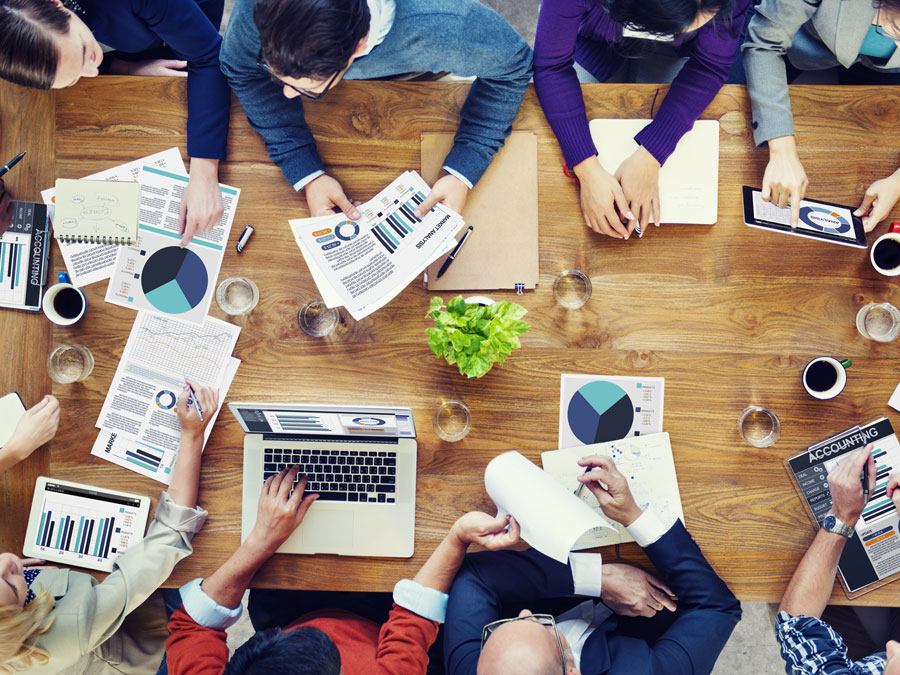Employees of a company discussing at a table